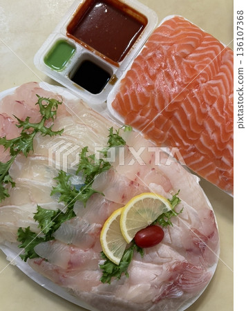 Fresh and delicate sashimi slices, beautifully presented with vibrant colors and perfect cuts. This traditional Japanese delicacy highlights the pure flavors of premium seafood. Fresh and delicate sashimi slices, beautifully presented with vibrant colors and perfect cuts. This traditional Japanese delicacy highlights the pure flavors of premium seafood. 136107368