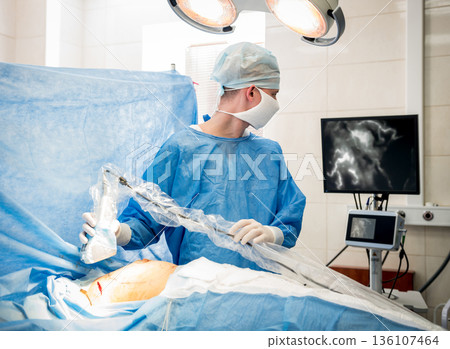 The surgeon uses a portable fluorescence imaging device during breast removal. The surgeon uses a portable fluorescence imaging device during breast removal. 136107464