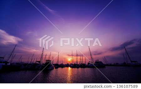 Beautiful view of marina and harbor with yachts and motorboats.  136107589