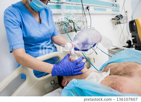 Doctors give resuscitation to a male patient in the emergency room. Doctors give resuscitation to a male patient in the emergency room. 136107607