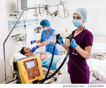 Doctors give resuscitation to a male patient in the emergency room. Doctors give resuscitation to a male patient in the emergency room. 136107609