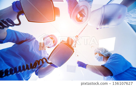 Doctors give resuscitation to a male patient in the emergency room. 136107627