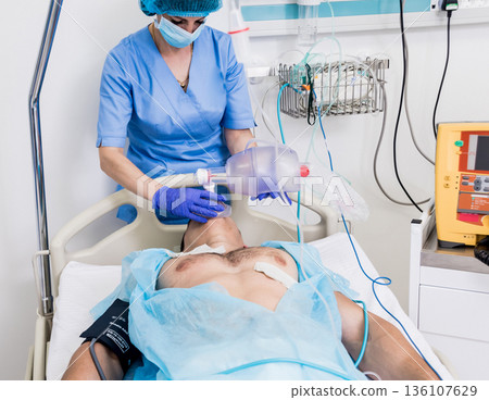 Doctors give resuscitation to a male patient in the emergency room. Doctors give resuscitation to a male patient in the emergency room. 136107629
