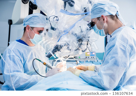 Spinal surgery. Group of surgeons in operating room with surgery equipment. Spinal surgery. Group of surgeons in operating room with surgery equipment. 136107634