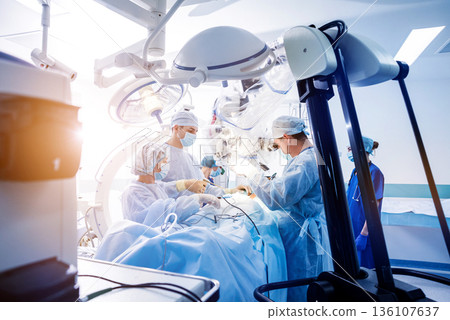 Spinal surgery. Group of surgeons in operating room with surgery equipment. Spinal surgery. Group of surgeons in operating room with surgery equipment. 136107637