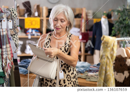 Elderly women choosing handbag in store 136107659