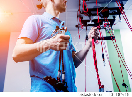 Physiotherapy. Suspension training therapy. Young man doing fitness traction Physiotherapy. Suspension training therapy. Young man doing fitness traction 136107666