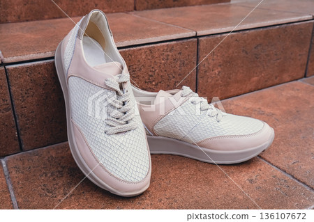 Fresh beige leather sneakers without brand marks displayed. For design templates online shops and sustainability-themed marketing. Clean blank sneakers Fresh beige leather sneakers without brand marks displayed. For design templates online shops and sustainability-themed marketing. Clean blank sneakers 136107672