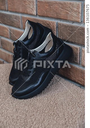 Elegant black leather womens shoes blank product for branding displayed. New casual female sneakers no-brand footwear e-commerce. No logo product Elegant black leather womens shoes blank product for branding displayed. New casual female sneakers no-brand footwear e-commerce. No logo product 136107675