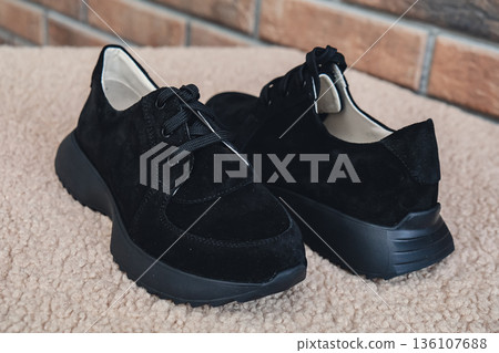 Elegant black leather womens shoes blank product for branding displayed. New casual female sneakers no-brand footwear e-commerce. No logo product Elegant black leather womens shoes blank product for branding displayed. New casual female sneakers no-brand footwear e-commerce. No logo product 136107688