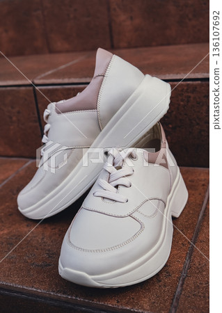 Fresh beige leather sneakers without brand marks displayed. For design templates online shops and sustainability-themed marketing. Clean blank sneakers Fresh beige leather sneakers without brand marks displayed. For design templates online shops and sustainability-themed marketing. Clean blank sneakers 136107692