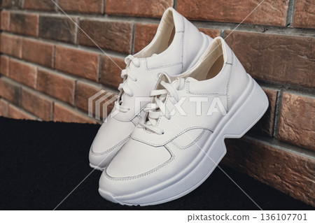 Fresh beige leather sneakers without brand marks displayed. For design templates online shops and sustainability-themed marketing. Clean blank sneakers Fresh beige leather sneakers without brand marks displayed. For design templates online shops and sustainability-themed marketing. Clean blank sneakers 136107701