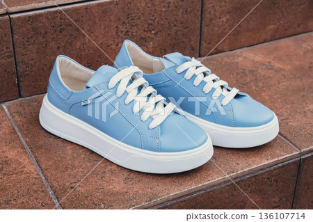 Elegant blue leather womens shoes blank product for branding displayed. New casual female sneakers no-brand footwear e-commerce. No logo product unbranded fashion 136107714