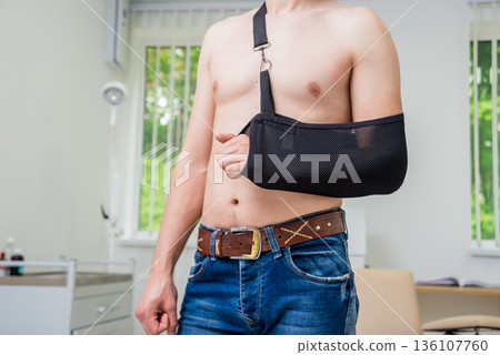Man with a arm sling. Broken arm, shoulder. Man with a arm sling. Broken arm, shoulder. 136107760