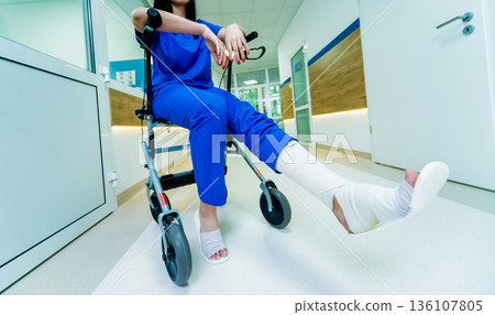 Patient on rollator with hand brakes moving in hospital Patient on rollator with hand brakes moving in hospital 136107805