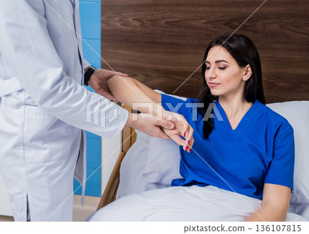 Traumatologist examining patient hands in modern hospital Traumatologist examining patient hands in modern hospital 136107815