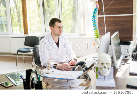 Two doctors having medical council in hospital. Discussing medical issues. Two doctors having medical council in hospital. Discussing medical issues. 136107893
