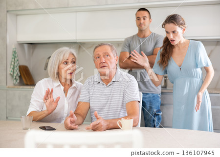 Family quarrel - couple is unhappy with elderly parents, express dissatisfaction 136107945