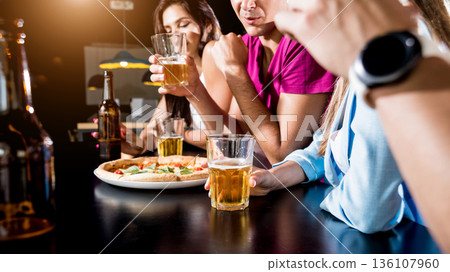 Cheerful friends in the pub. Drinking beer, wine and whisky Cheerful friends in the pub. Drinking beer, wine and whisky 136107960