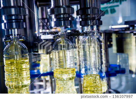 Bottling line of sunflower oil in bottles. Vegetable oil production plant 136107997
