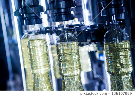 Bottling line of sunflower oil in bottles. Vegetable oil production plant Bottling line of sunflower oil in bottles. Vegetable oil production plant 136107999