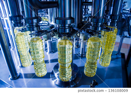 Bottling line of sunflower oil in bottles. Vegetable oil production plant Bottling line of sunflower oil in bottles. Vegetable oil production plant 136108009