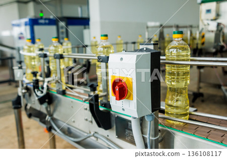 Bottling line of sunflower oil in bottles. Vegetable oil production plant 136108117