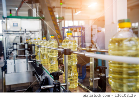 Bottling line of sunflower oil in bottles. Vegetable oil production plant. Bottling line of sunflower oil in bottles. Vegetable oil production plant. 136108129