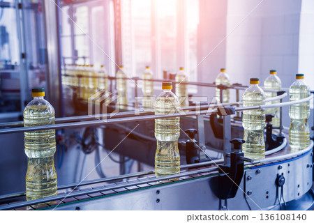 Bottling line of sunflower oil in bottles. Vegetable oil production plant. 136108140