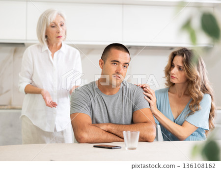 Young couple quarrel with mother Young couple quarrel with mother 136108162