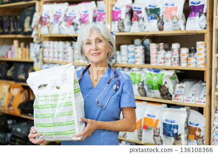 Smiling female veterinarian recommending healthy dry pet food 136108366