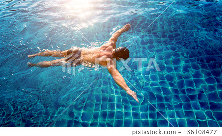 Young athletic man swimming in the swimming pool Young athletic man swimming in the swimming pool 136108477