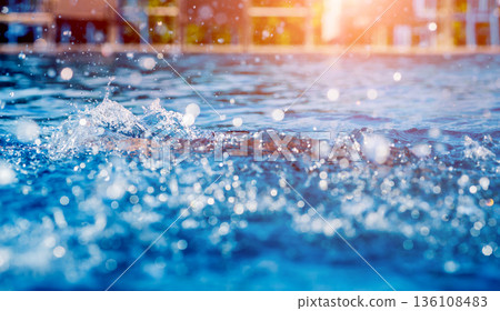 Young athletic man swimming in the swimming pool 136108483