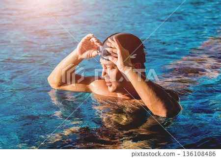 Young athletic man swimming in the swimming pool Young athletic man swimming in the swimming pool 136108486