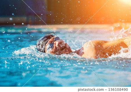Young athletic man swimming in the swimming pool Young athletic man swimming in the swimming pool 136108490