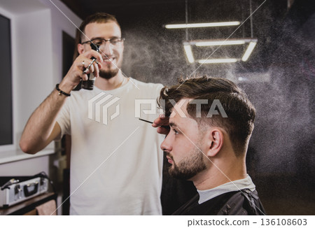 Young man with trendy haircut at barber shop. Young man with trendy haircut at barber shop. 136108603