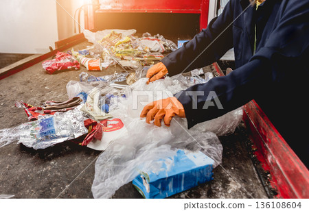 At modern recycling plant. Separate garbage collection. Workers sorting trash At modern recycling plant. Separate garbage collection. Workers sorting trash 136108604