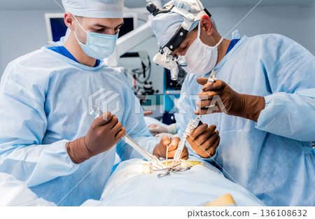 Spinal surgery. Group of surgeons in operating room Spinal surgery. Group of surgeons in operating room 136108632