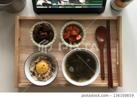 Warm and comforting jibbap (home-cooked Korean meal) with a spread of rice, soup, and banchan, offering a perfect harmony of flavor, tradition, and heartwarming nourishment in every bite. 136108659