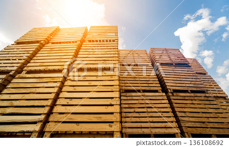 Wooden boxes stacked on each other. Outdoors. Blue sky background Wooden boxes stacked on each other. Outdoors. Blue sky background 136108692