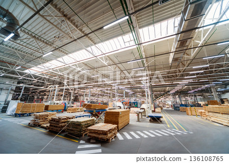 Production line of the wooden floor factory. CNC automatic woodworking machine. Production line of the wooden floor factory. CNC automatic woodworking machine. 136108765