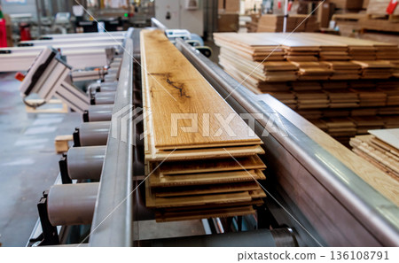 Production line of the wooden floor factory. CNC automatic woodworking machine. Production line of the wooden floor factory. CNC automatic woodworking machine. 136108791