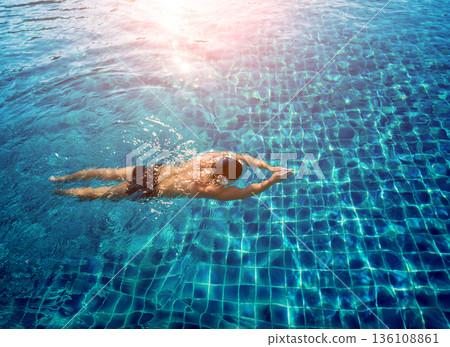 Young athletic man swimming in the swimming pool Young athletic man swimming in the swimming pool 136108861