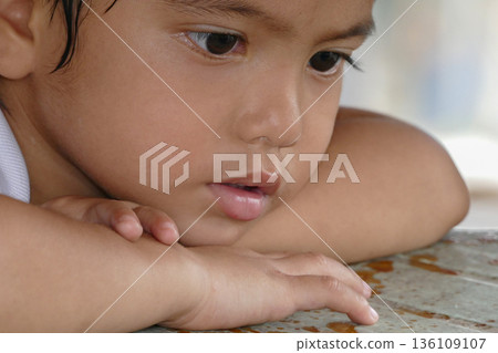 Closeup cute portrait of Asian little boy absent-minded 136109107