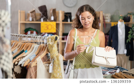Young women choosing handbag in store Young women choosing handbag in store 136109359