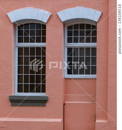 Vintage metal windows on red brick wall of the house in old town Vintage metal windows on red brick wall of the house in old town 136109518