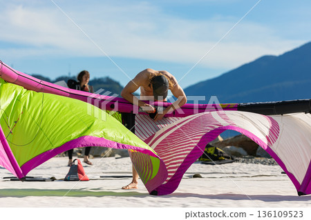 Kiteboarder on the beach prepare sport equipment for riding. Squamish,BC,Canada. watersports. Kiteboarder on the beach prepare sport equipment for riding. Squamish,BC,Canada. watersports. 136109523