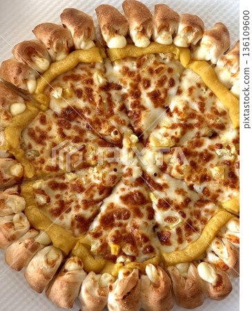 A delicious pizza with a golden crust, melted cheese, and savory toppings. Perfect for food-related designs, menus, or Italian-themed projects, capturing the essence of a classic comfort dish. 136109600