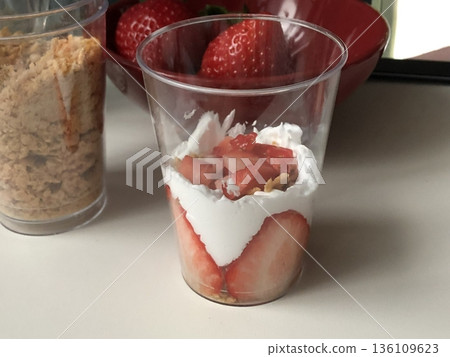 Healthy breakfast of strawberry parfait made with fresh fruit, and yogurt over a rustic white table. Selective focus with blurred background and foreground. 136109623