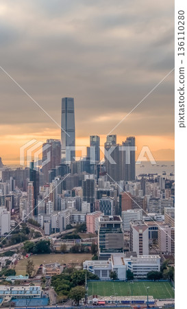 Warm Sunset Illuminates Yau Tsim Mong Skyline And Harbour 136110280